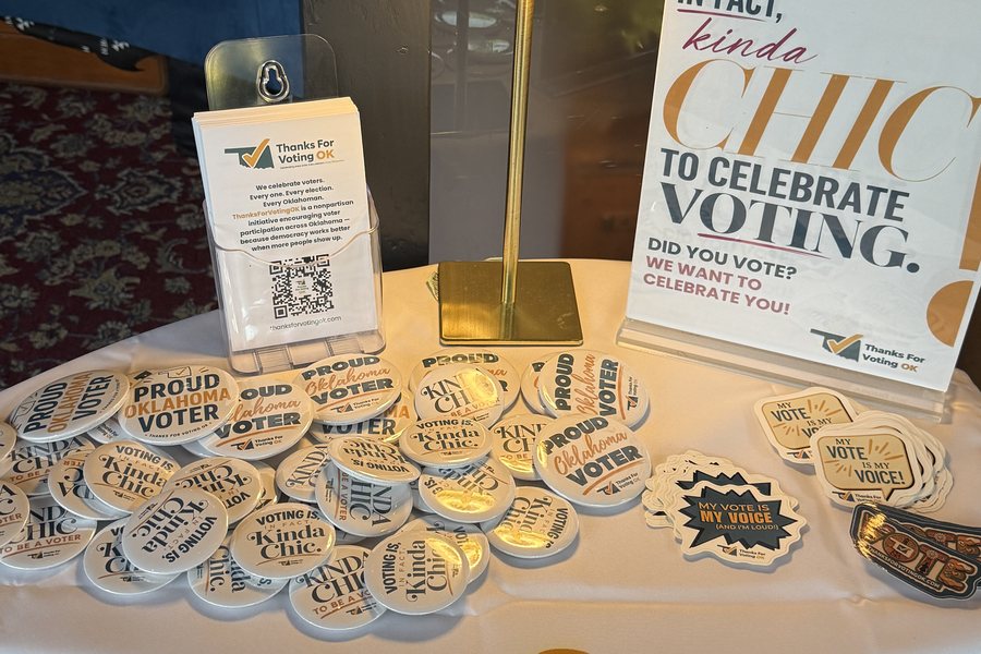 Thanks For Voting OK buttons and stickers on a celebration stop table, reading Proud Oklahoma Voter, Voting Is Kinda Chic, and My Vote Is My Voice